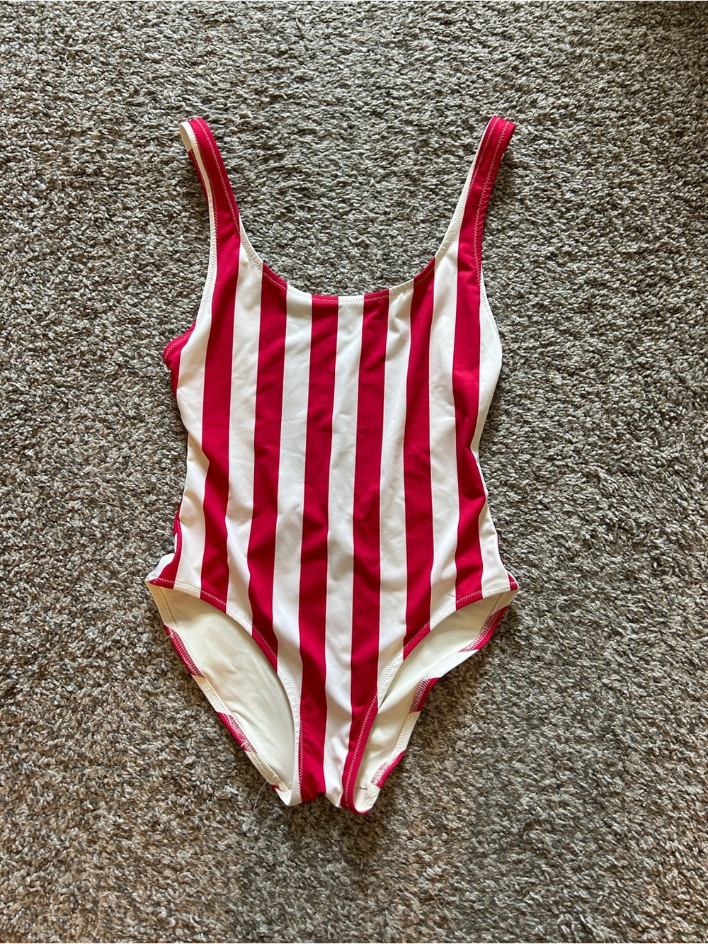 TWO solid and striped one piece bathing suits